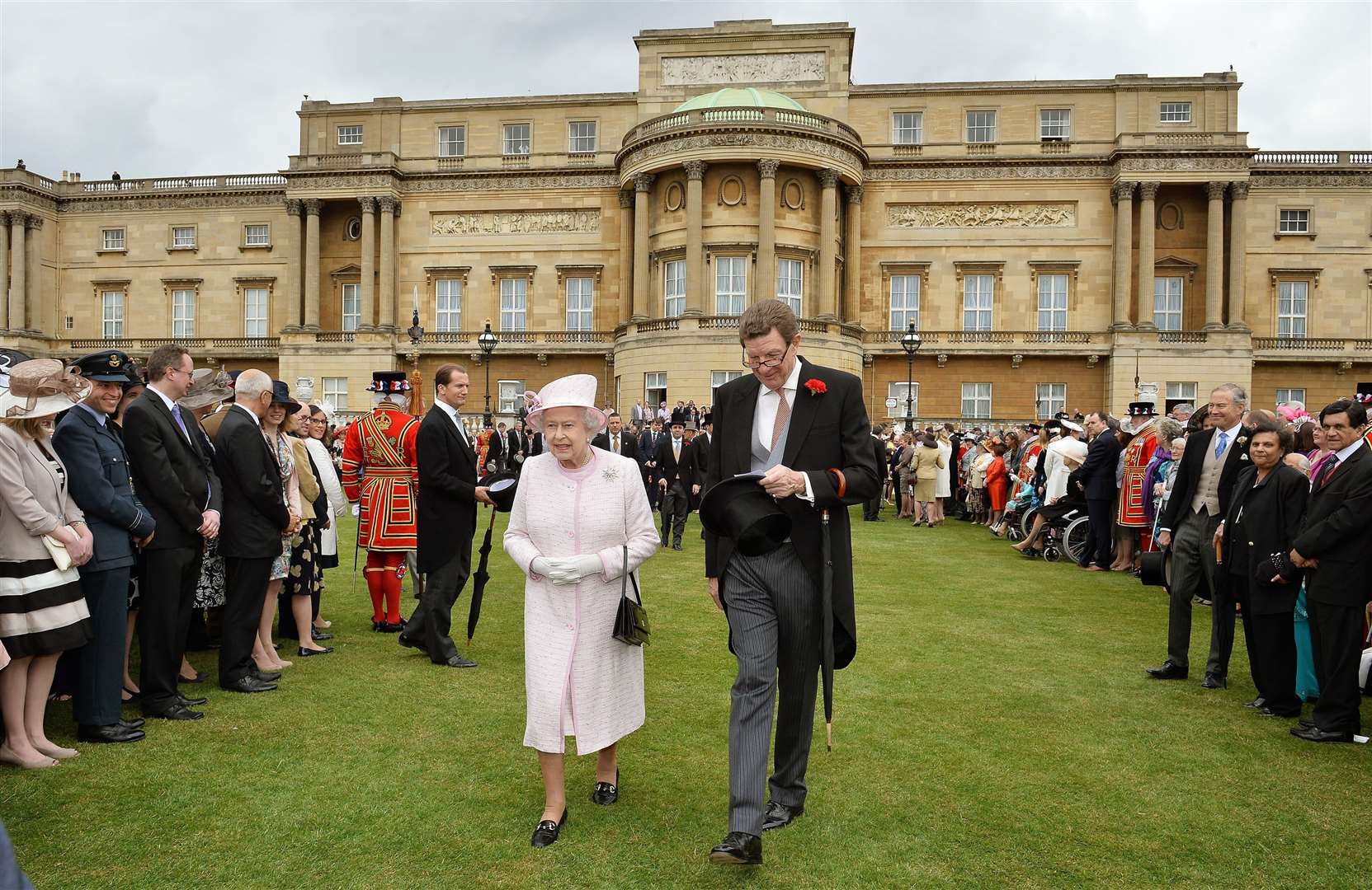 The Queen with the Lord Chamberlain at a garden party in the grounds of Buckingham Palace (John Stillwell/PA)