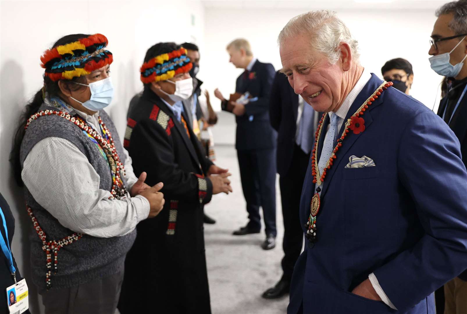 Charles is presented with a necklace by an Ecuadorian member of the Global Alliance of Territorial Communities (Chris Jackson/PA)