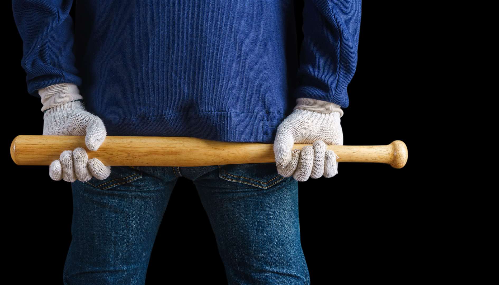 Man holding a baseball bat on black background (5636943)