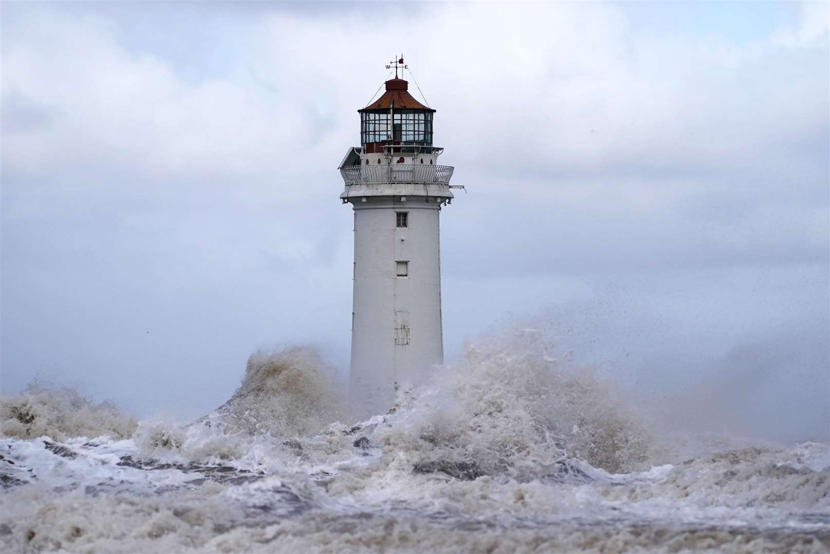 Huge waves lash the lighthouse at New Brighton, Merseyside (Peter Byrne/PA)