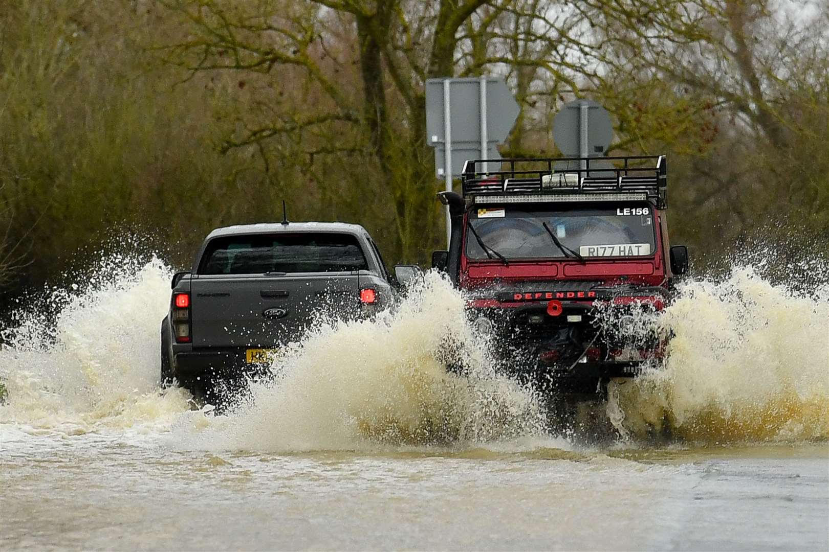 Vehicles navigate the flooded Mountsorrel Lane in Leicestershire (Jacob King/PA)