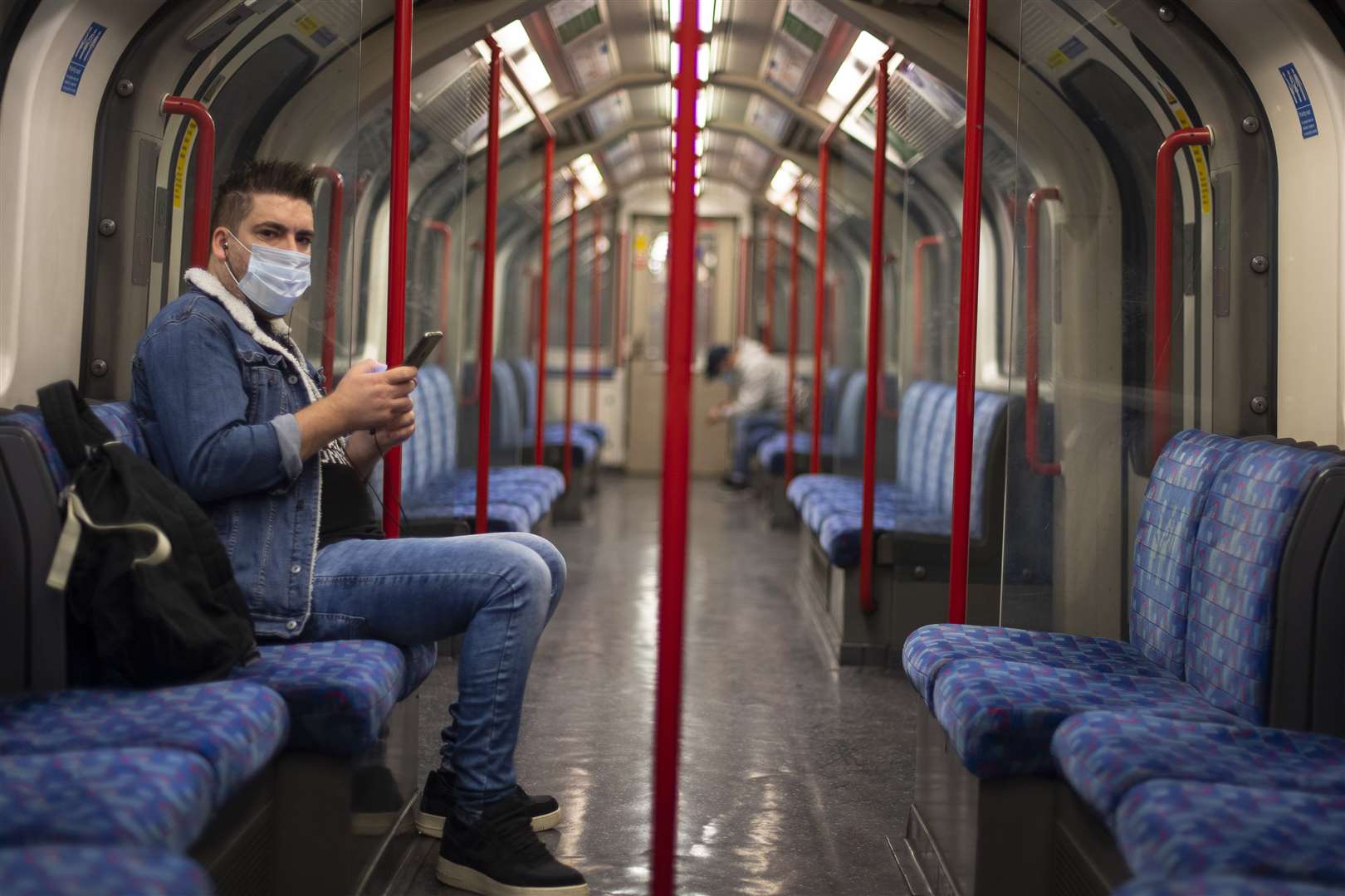 A passenger wearing a face mask on the Central line (Victoria Jones/PA)