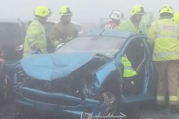 Firefighters with one of the badly-damaged cars. Picture: @westhambucky