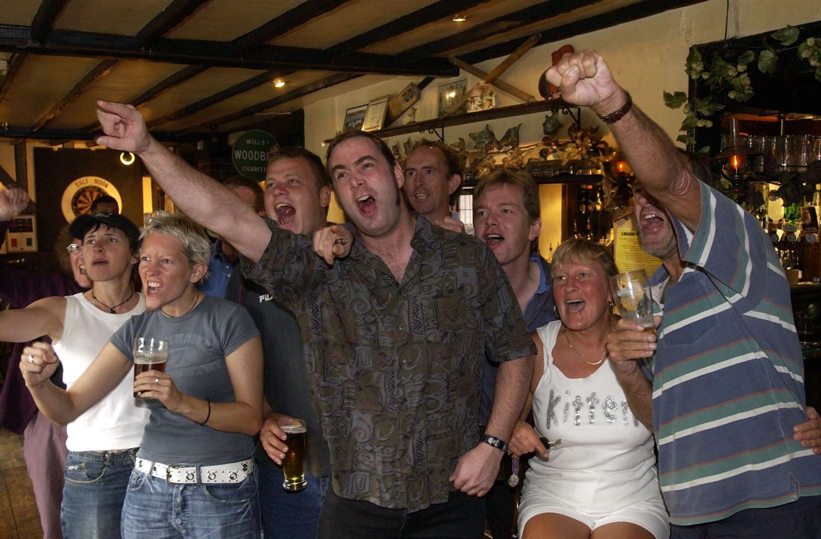 Locals at The Half Moon in Hildenborough were over the moon as they watch Kelly Holmes win her second gold medal at the Athens Olympics in August 2004. The pub is still going today. Picture: John Wardley