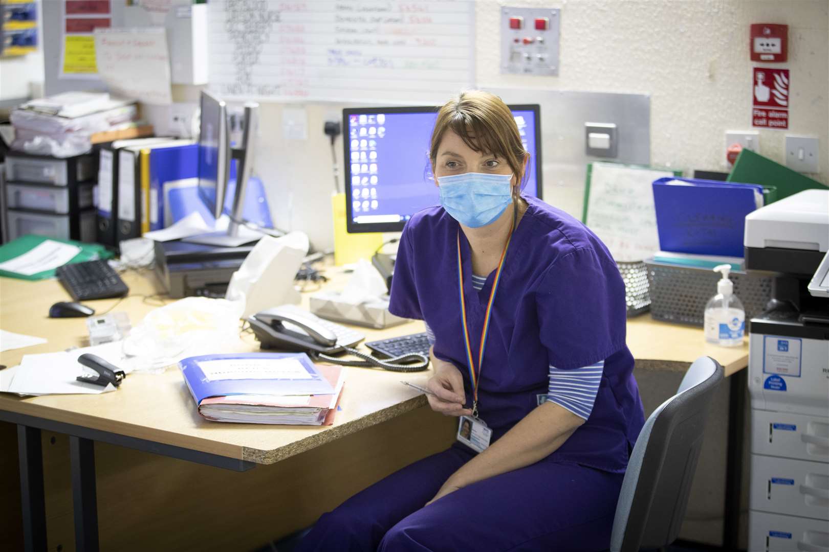 Dr Lucy McCracken working at her desk in a Covid red ward (Jane Barlow/PA)