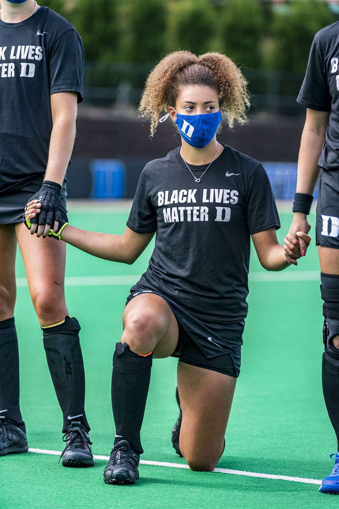 England Under-21 hockey player Darcy Bourne, wearing a Black Lives Matter T-shirt, takes a knee before a match for Duke University, North Carolina (Duke Athletics Photography)