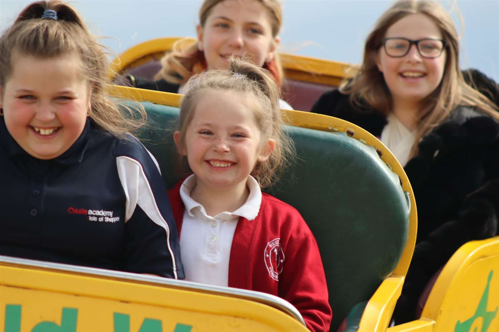 Girls riding the Wild West rollercoaster at Smith's funfair, Barton's Point, Sheerness