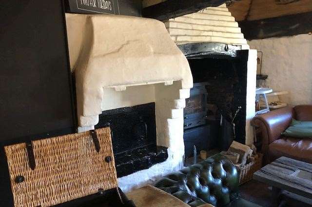 To the right of this picture is the dining room. The double-sided wood burner, to the left, is the original bread oven