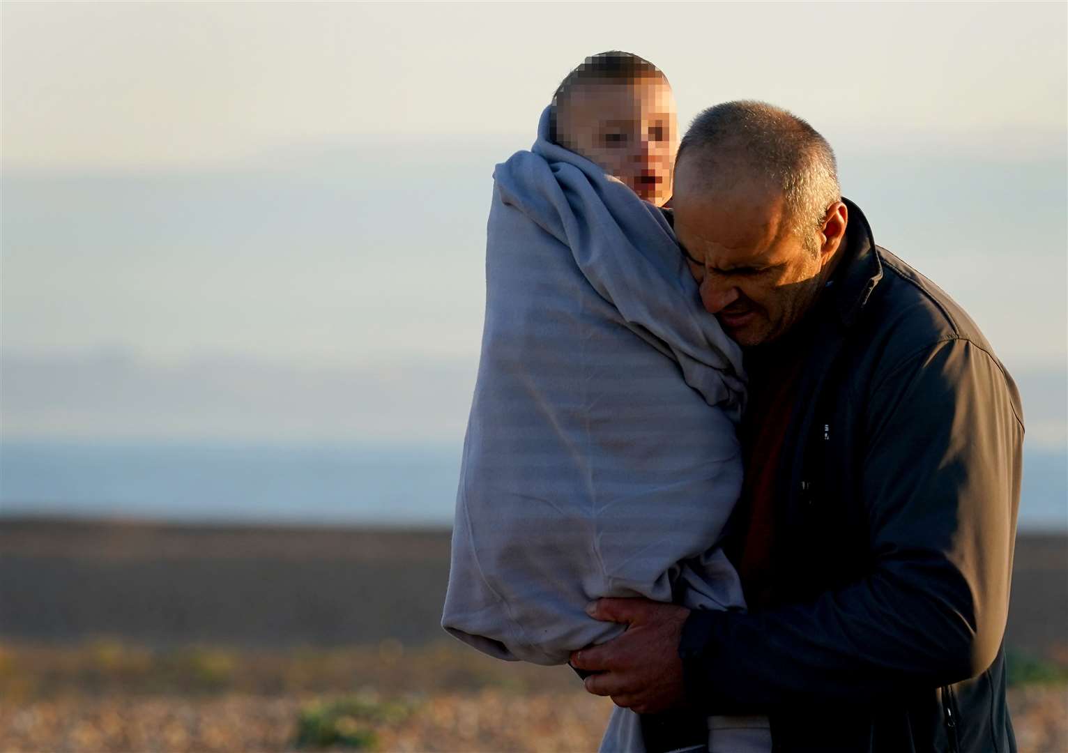 Children wrapped in blankets were carried to safety after crossing the Channel on Wednesday (Gareth Fuller/PA)