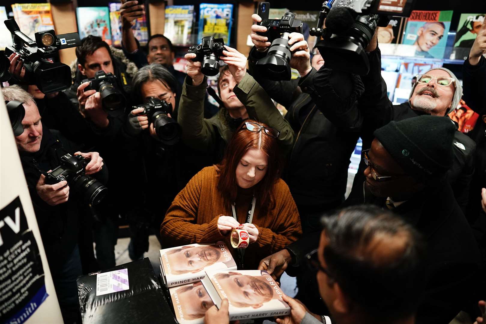 Media photograph staff at WH Smiths at Victoria Station in London (PA)