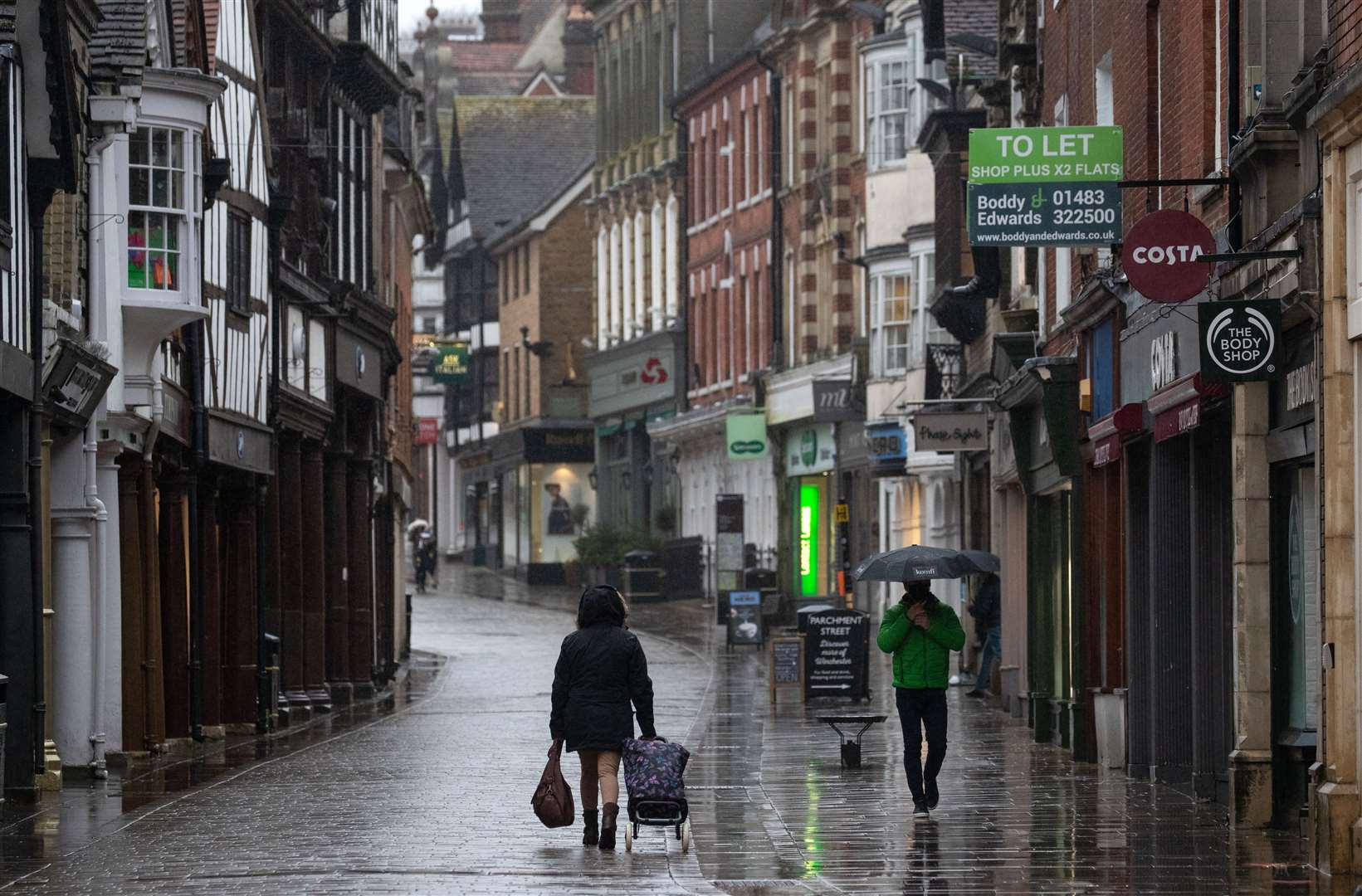 People walk up and down the High street in Winchester, Hampshire, as Storm Christoph is set to bring widespread flooding, gales and snow (Andrew Matthews/PA)