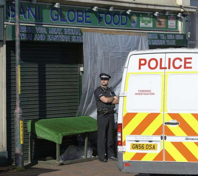 Police outside the Luton shop where Harjit Chaggar's body was found