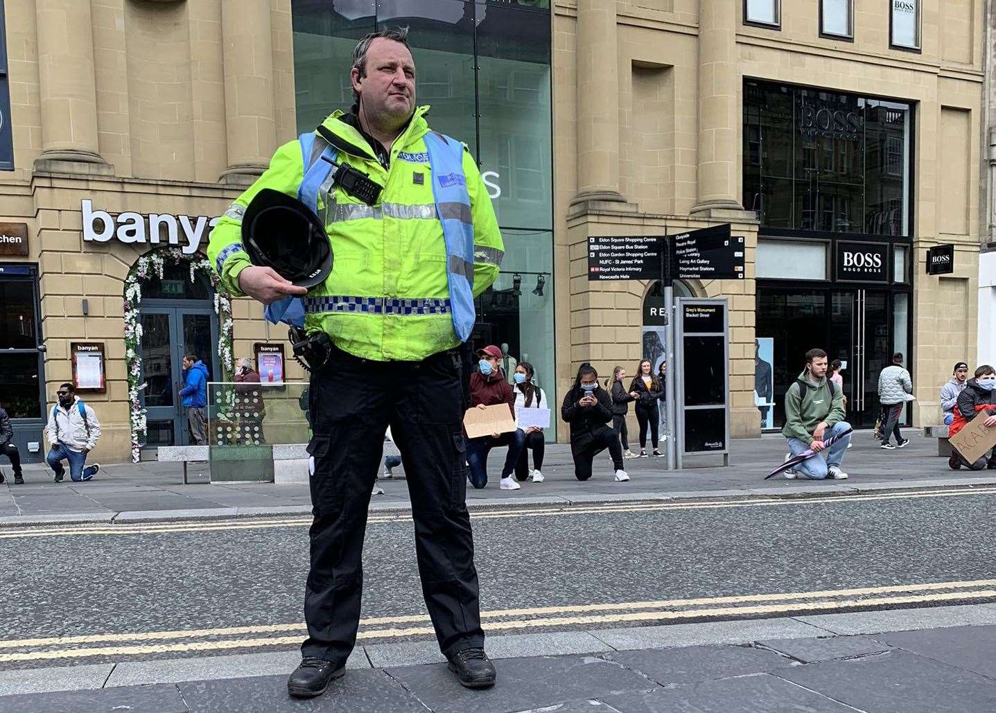 A police officer took off his helmet during a minute’s silence in Newcastle (Dr Christina Mobley/PA)