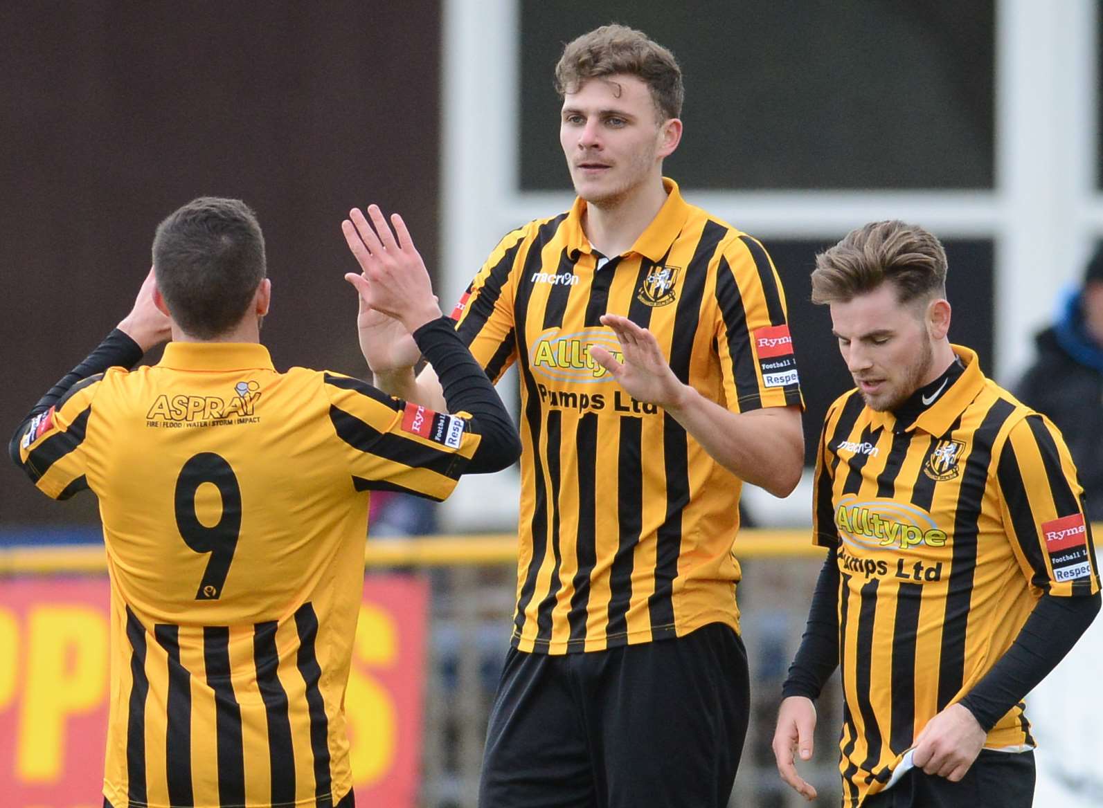 Harry Smith (centre) celebrates scoring for Folkestone Picture: Gary Browne