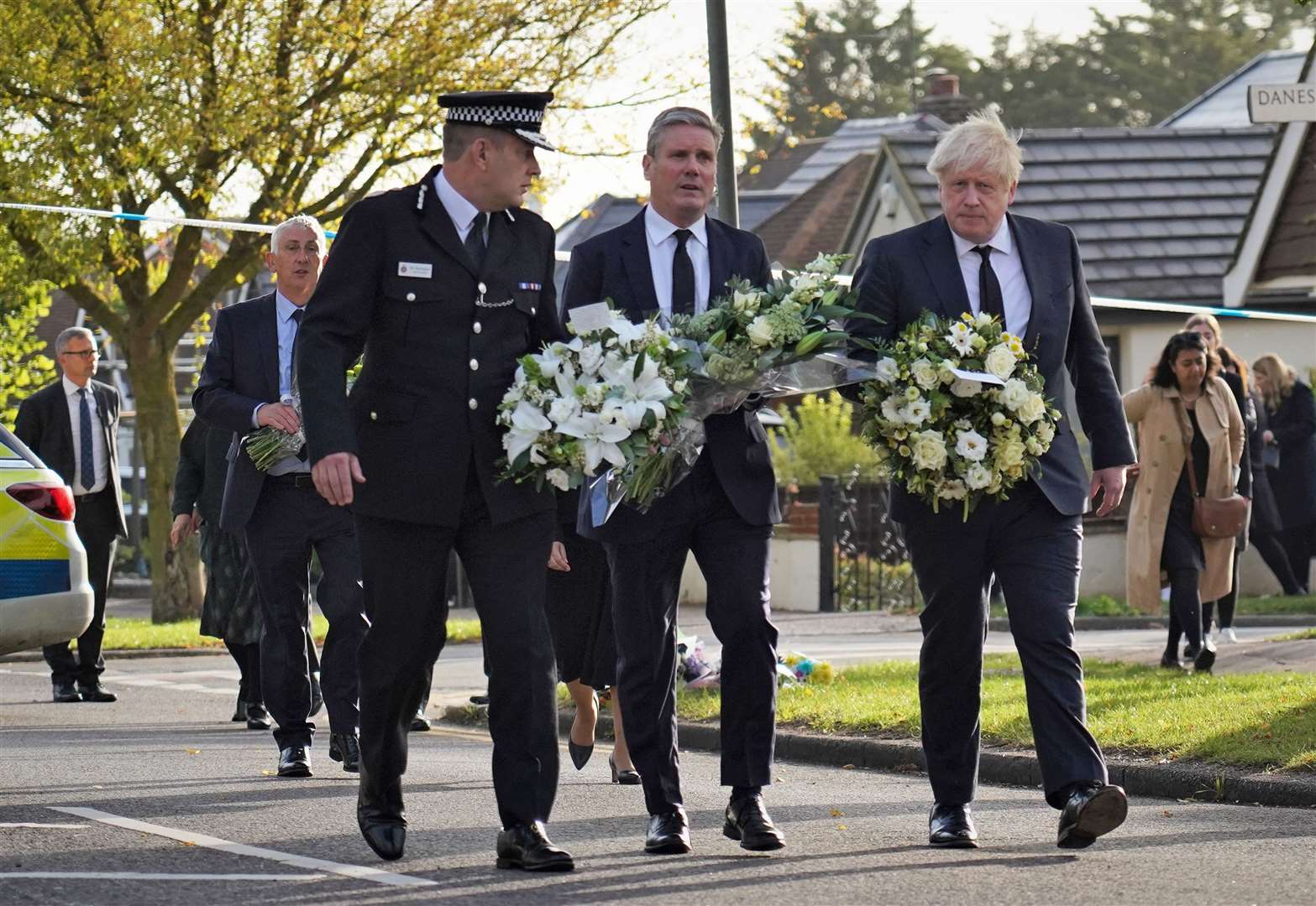 Essex Police chief Ben-Julian Harrington, Labour leader Sir Keir Starmer and Prime Minister Boris Johnson carry flowers as they arrive at Belfairs Methodist Church in Leigh-on-Sea to pay tribute to Sir David (Essex Police/PA)