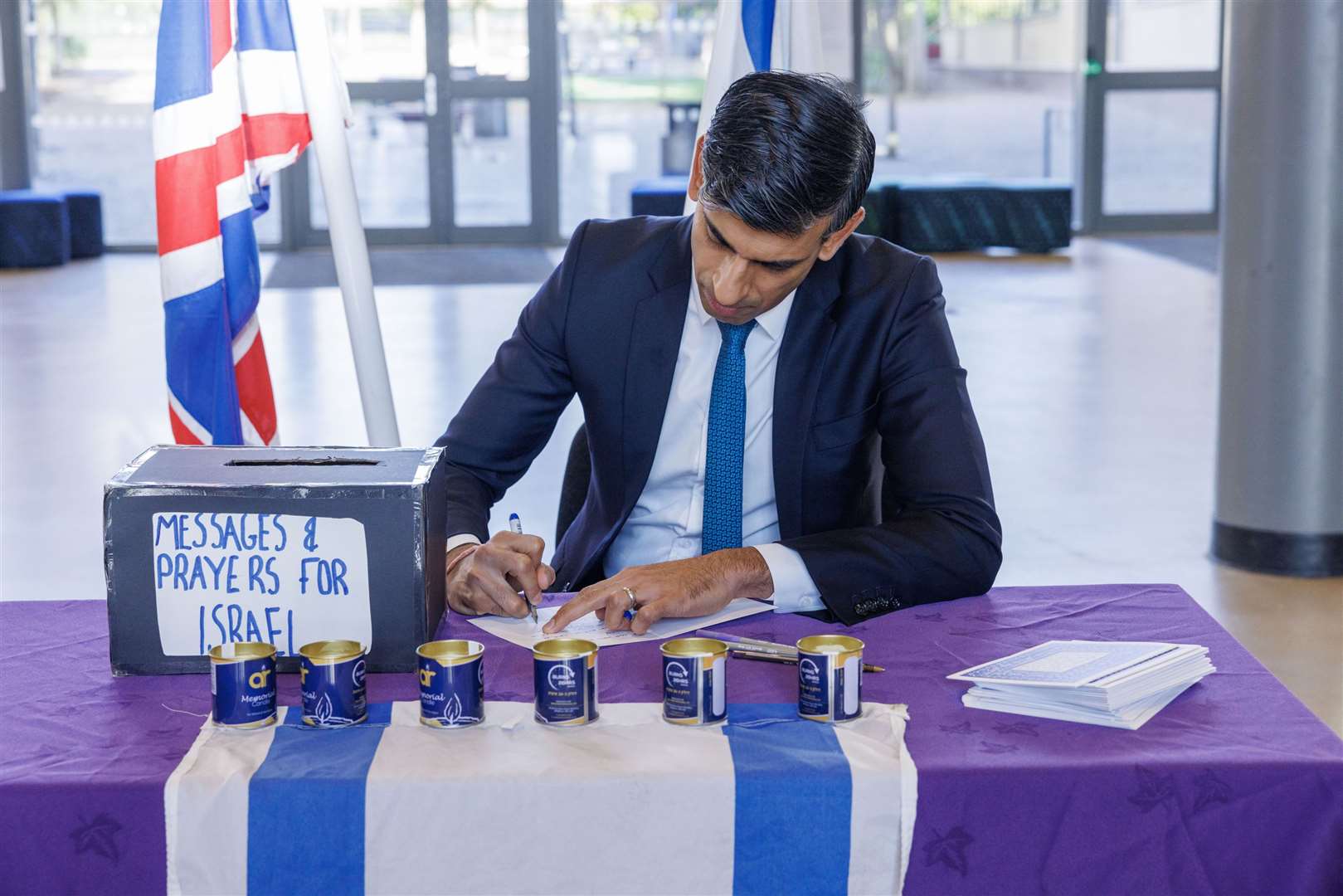 Prime Minister Rishi Sunak writes a message for Israel (Jonathan Buckmaster/Daily Express/PA)