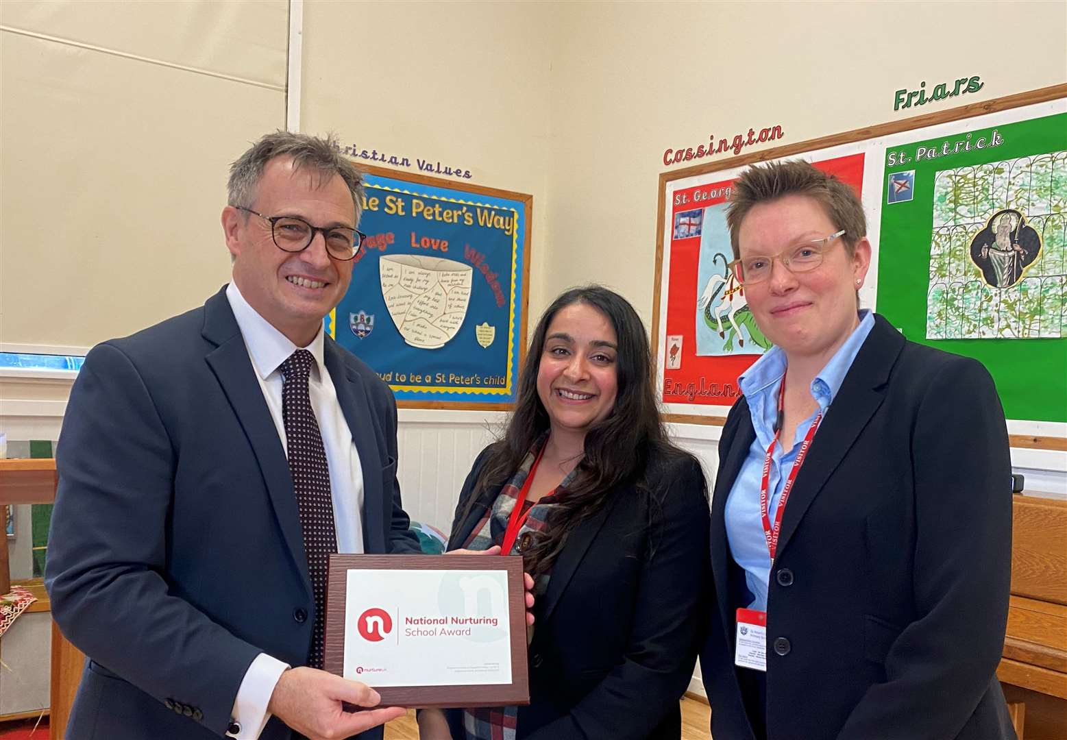 Head teacher Jim Holditch and MP Tracey Crouch (right) with the Nurture UK award