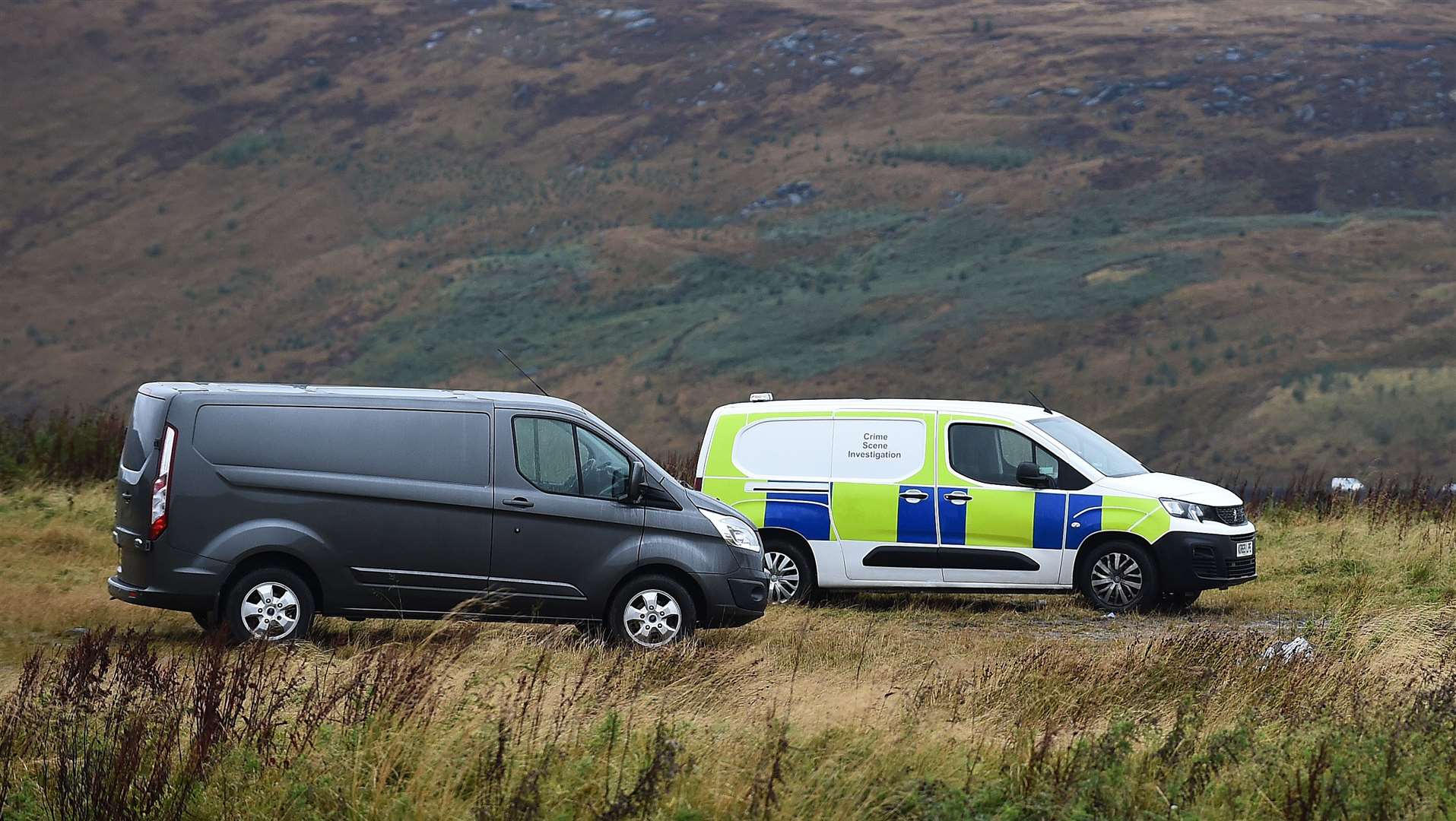 Vehicles parked near the search area (Peter Powell/PA)