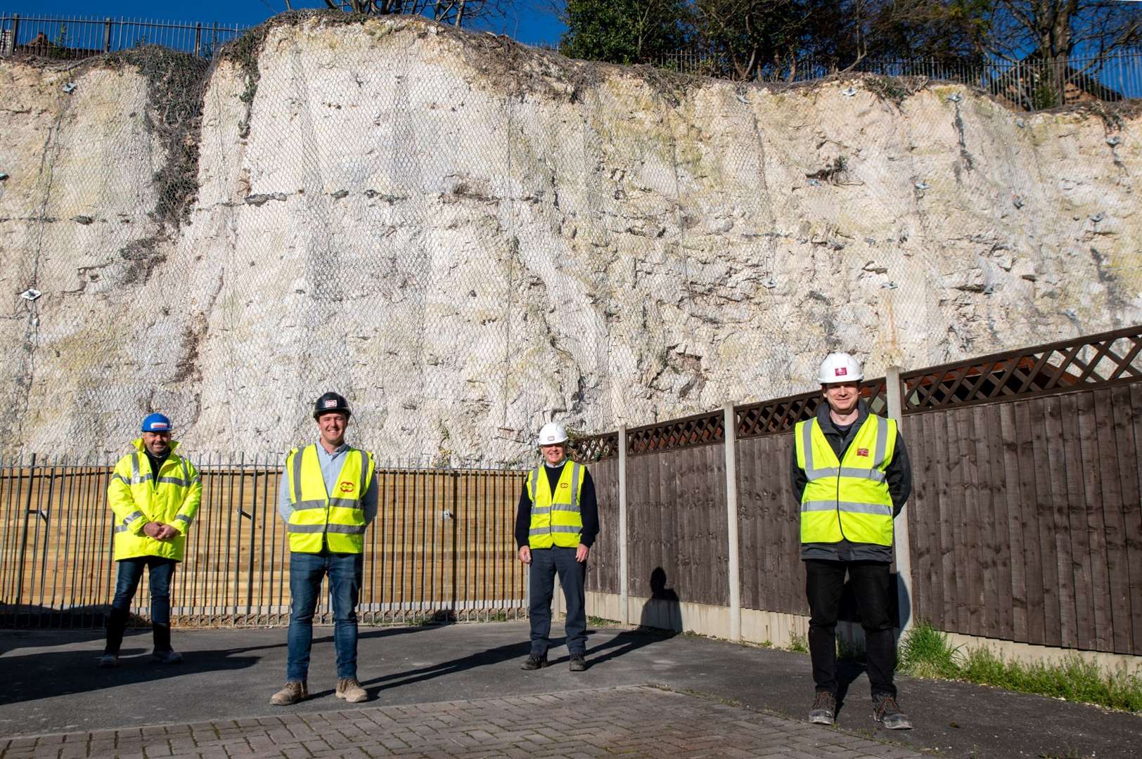 The cliff face next to Eagles Road has now been stabilised to prevent any future erosion. From left: Paul Koster, Housing Maintenance Manager at Dartford Borough Council, Alex Deysell, Site Agent at Clifford Devlin, Tim Clifford, Managing Director at Clifford Devlin and Andrew Wright, Director at Ingleton Wood. Picture: Clare Banks Photography