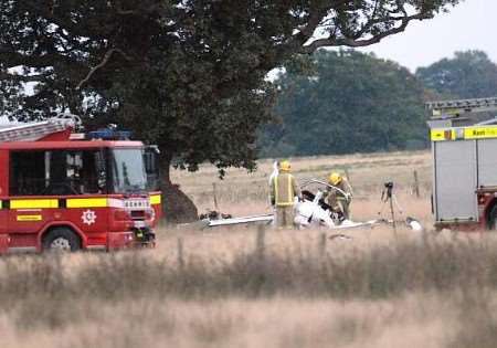 Firefighters and forensic officers at the scene of the tragedy. Picture: GARY BROWNE