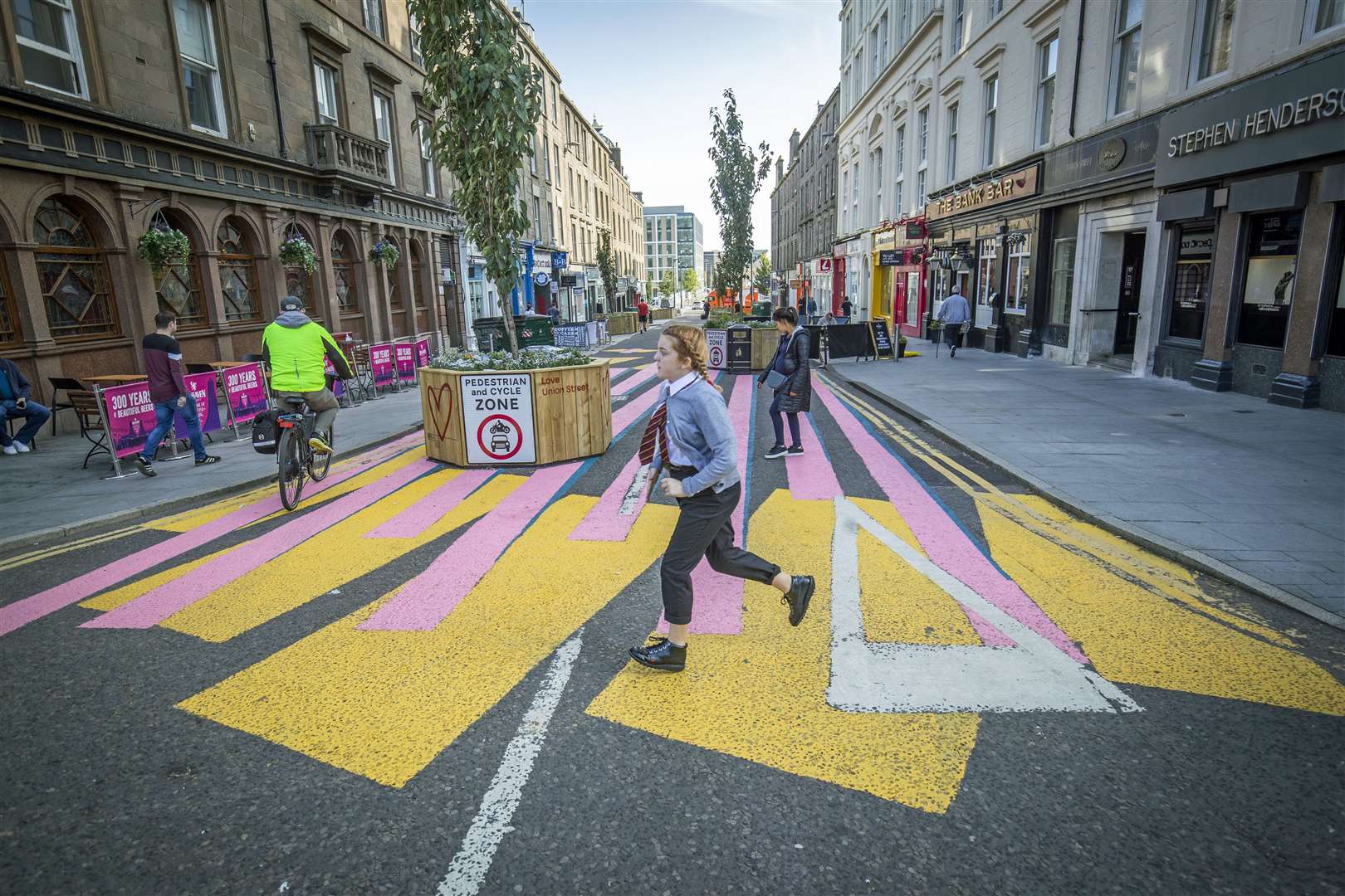 The newly pedestrianised Union Street in Dundee has been painted with a colourful zebra crossing-style mural to encourage people to explore the street (Jane Barlow/PA)