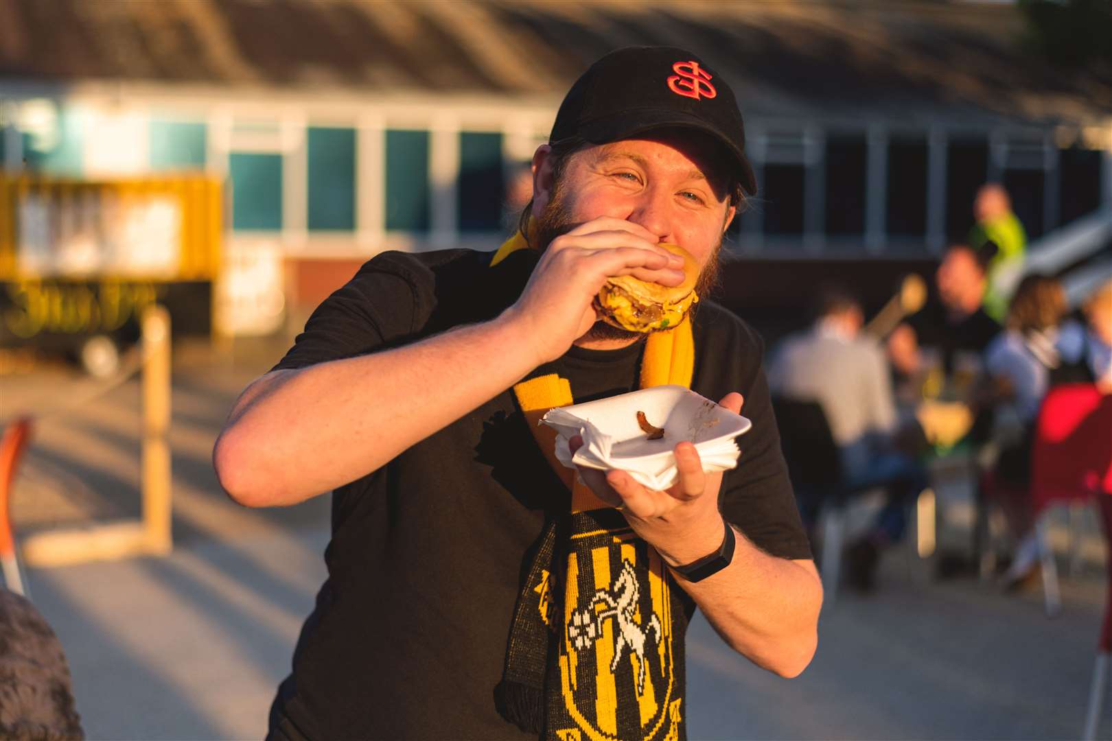 Reporter Rhys Griffiths tucking in to one of the burgers that have gone viral on social media. Picture: Ben O'Reilly