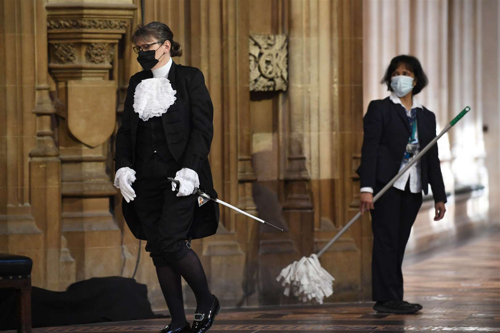 A parliamentary official walks past a cleaner in the Central Lobby (Stefan Rousseau/PA)