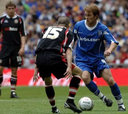 Gillingham's Stuart Lewis takes on Shrewsbury's Paul Murray at Wembley