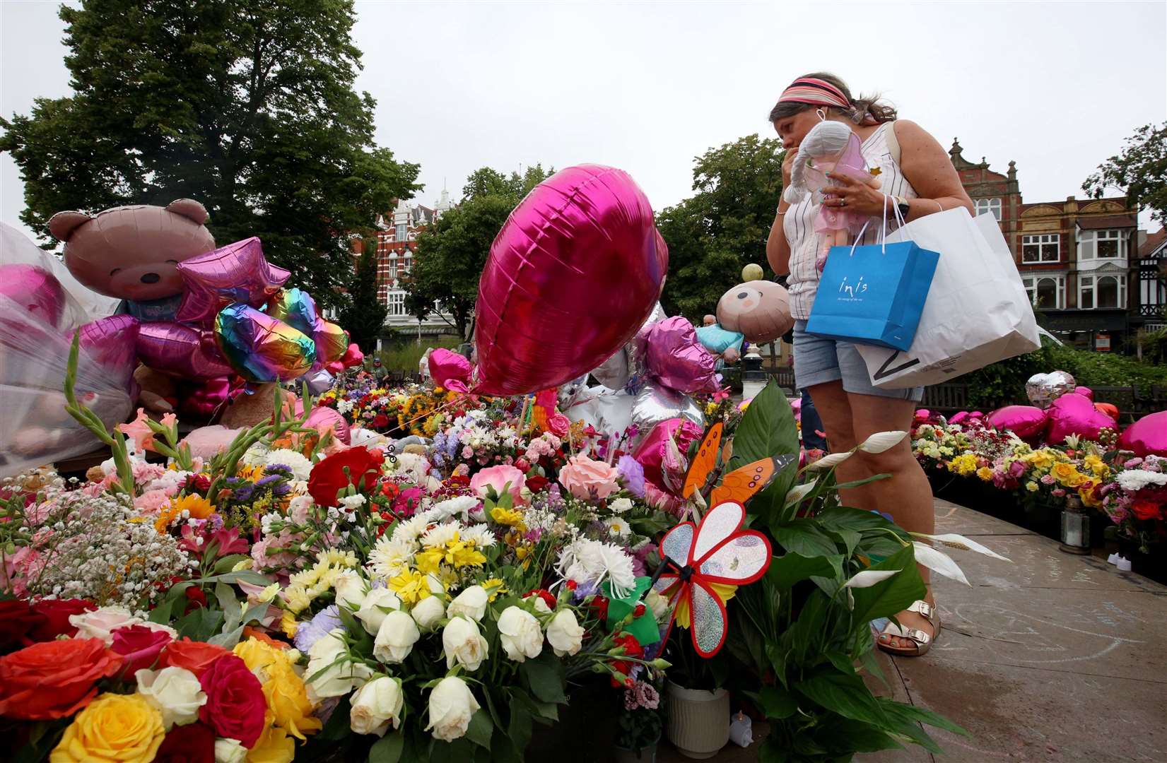 Members of the public look at floral tributes (Ryan Jenkinson/PA)