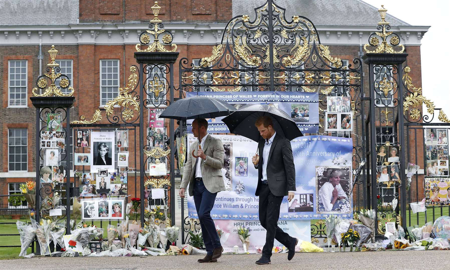 William and Harry looking at tributes to Diana, Princess of Wales at Kensington Palace, ahead of the 20th anniversary of her death in 2017 (Kirsty Wigglesworth/PA)