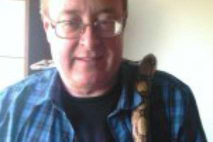 A Facebook picture shows Dale Bolinger with a pet snake around his neck