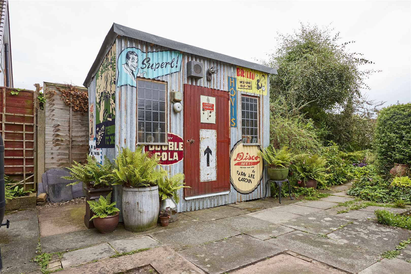 Wayne Dawber decorated the inside and outside of his shed with hand-painted murals and vintage signs (Cuprinol)