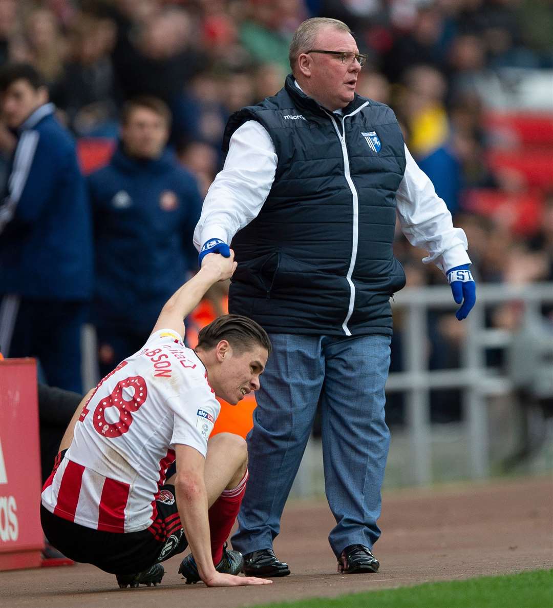 Gills boss Steve Evans gives Sunderland's George Dobson a helping hand on Saturday but the pre-match Fair Play handshake is currently on hold Picture: Ady Kerry