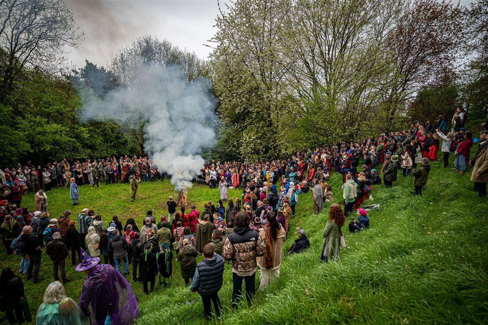 People watch the Beltane ceremony at Chalice Well, Glastonbury (Ben Birchall/PA)