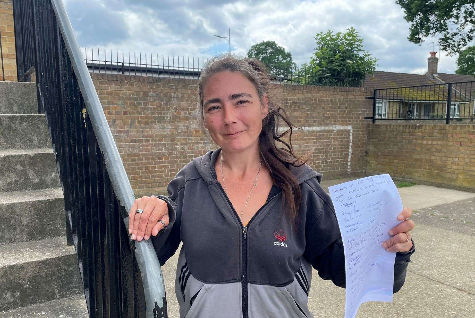 Chelsea Davidson with her petition against the terms and conditions of her housing policy. Picture: Joe Crossley