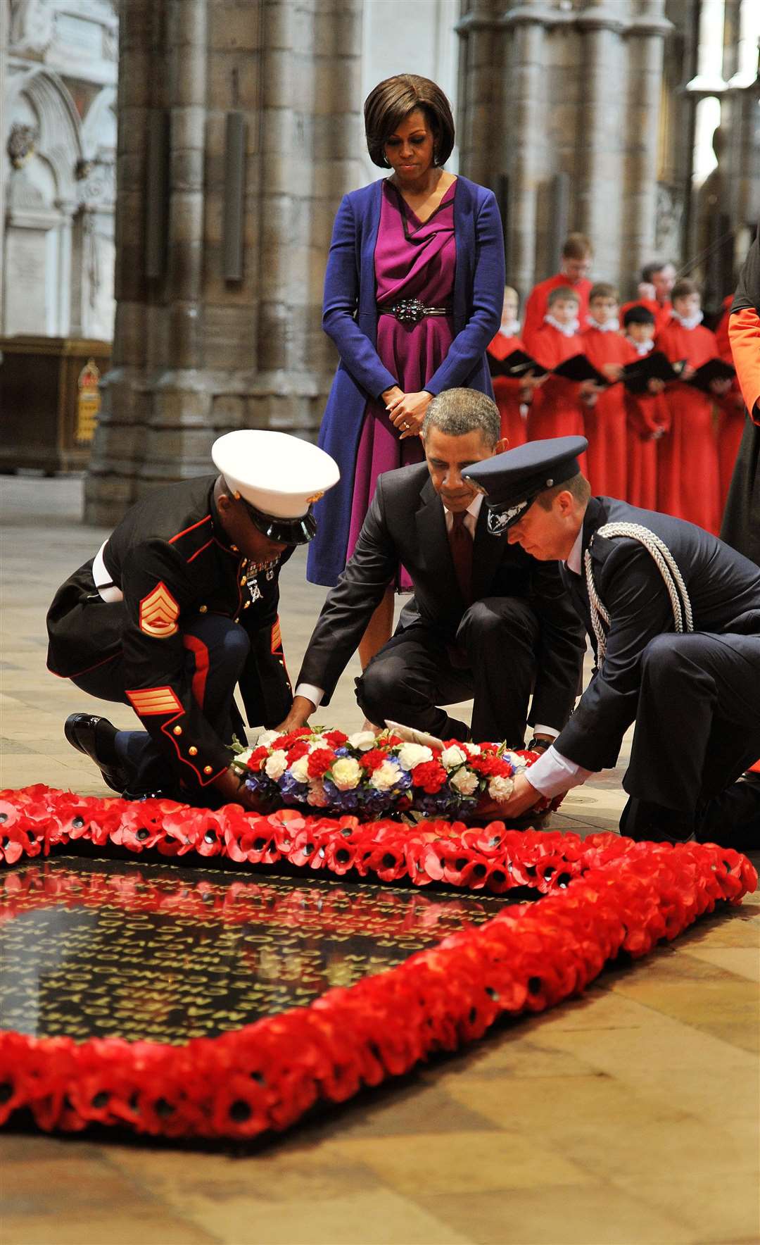 US president Barack Obama, watched by his wife Michelle, during a wreath-laying during his three-day state visit to the UK in 2011 (PA)