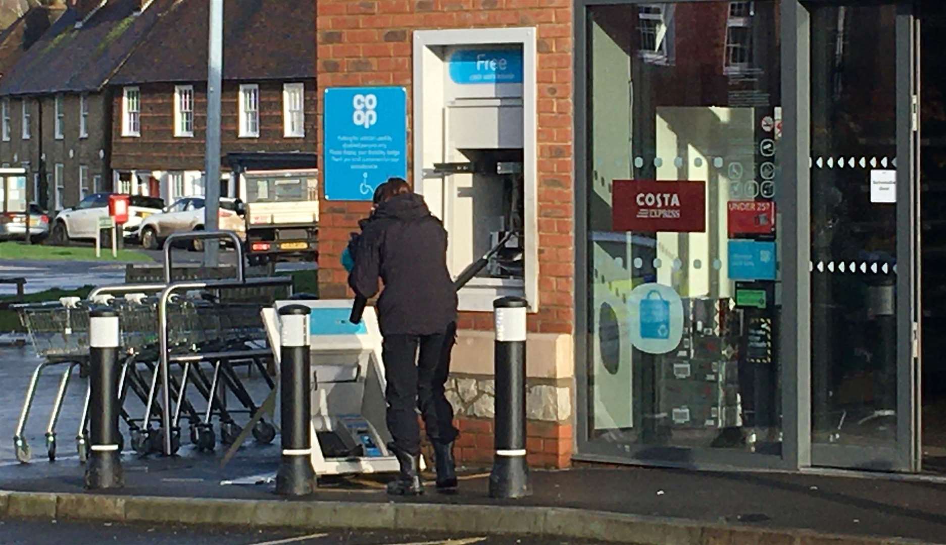 A forensic officer examiner the cash machine after an attempted theft in Harrietsham