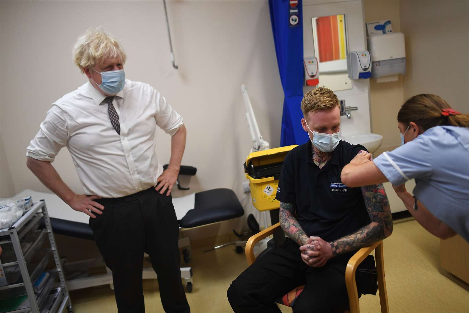 Prime Minister Boris Johnson watches as nurse Sandra Guy gives a Covid-19 booster jab during a visit to Hexham General Hospital in Northumberland (Peter Summers/PA)