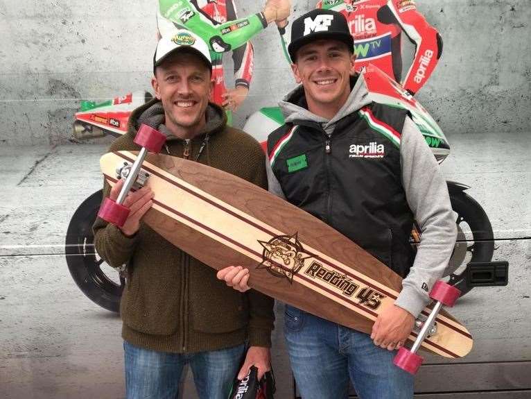 John Wingate with British motorcycle racer, Scott Redding, posing with a longboard handmade by John. Picture: Elizabeth Wingate