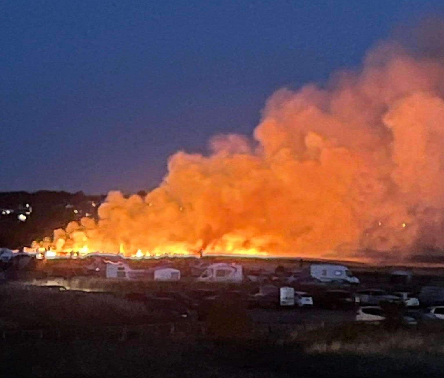 Fire and smoke billow from a huge grass fire at Barton's Point Coastal Park, Sheerness, Sheppey, on Saturday night. It is believed it was started by sparks from a model aeroplane fireworks display. Picture: Andy Gray (Facebook)