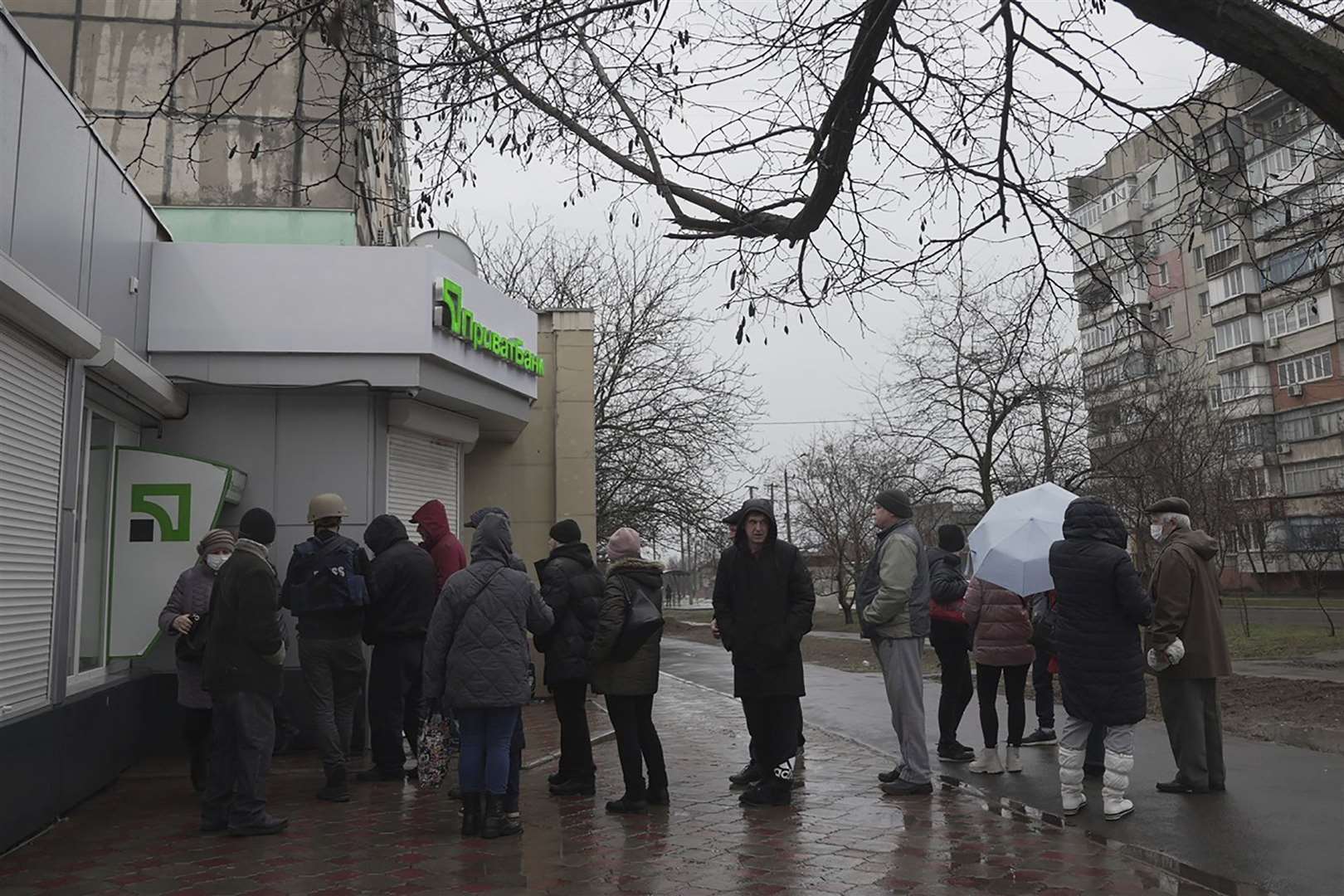 People line up to withdraw their money from an ATM in Mariupol, Ukraine (Evgeniy Maloletka/AP)