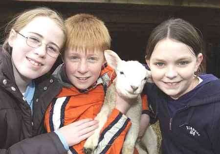 FURRY FRIEND: Pupils Rebecca Roots, Joe Collins and Laura Symons