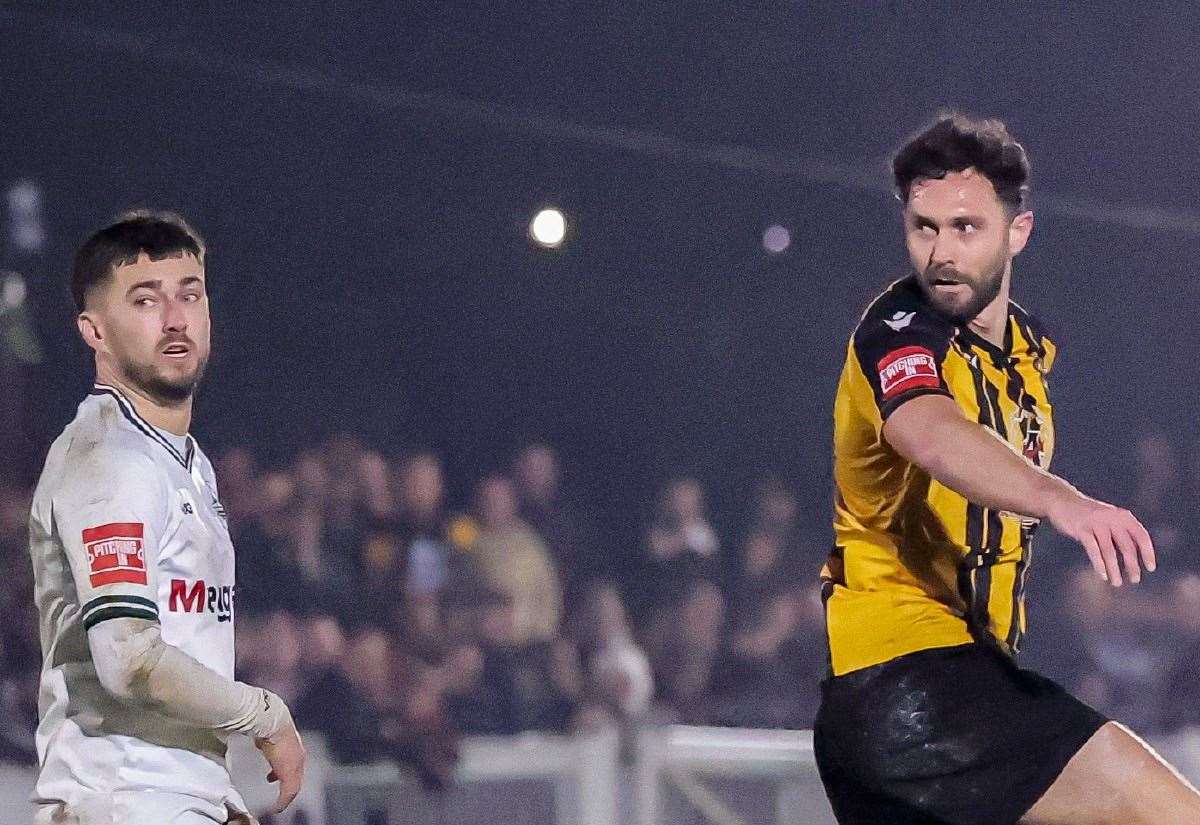 Dean Rance heads towards goal for Folkestone while Dover's Alfie Matthews watches on and George Wilkinson is on the ground as Whites won the Isthmian Premier game 1-0 on Tuesday night. Picture: Helen Cooper