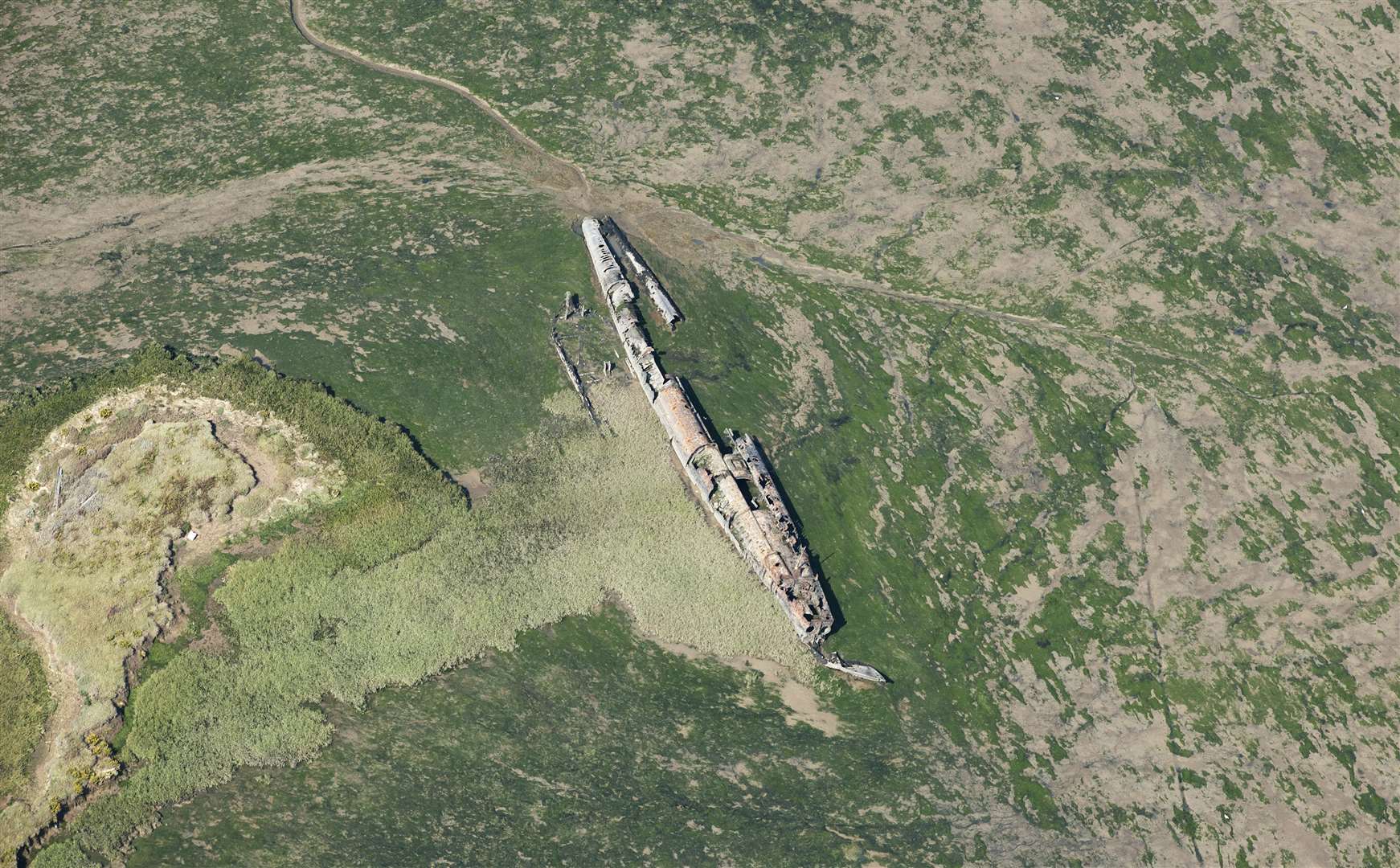 Remains of U-boat abandoned on the Kentish marshes, at Humble Bee Creek, Stoke Saltings, after being stripped and partially broken up in 1921 following surrender. Picture: English Heritage