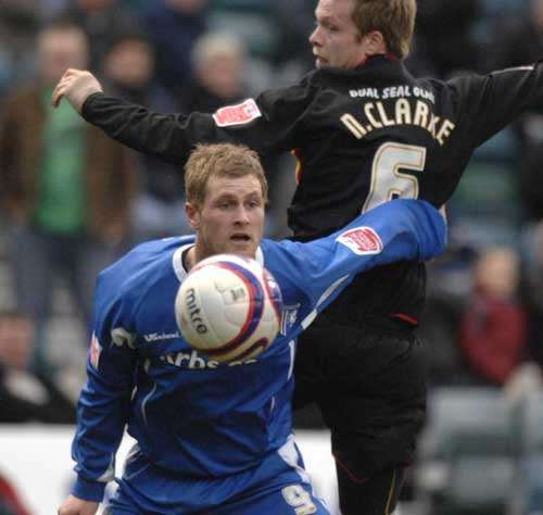 Gary Mulligan holds off Huddersfield's Nathan Clarke, who later gave away the decisive penalty. Picture: GRANT FALVEY