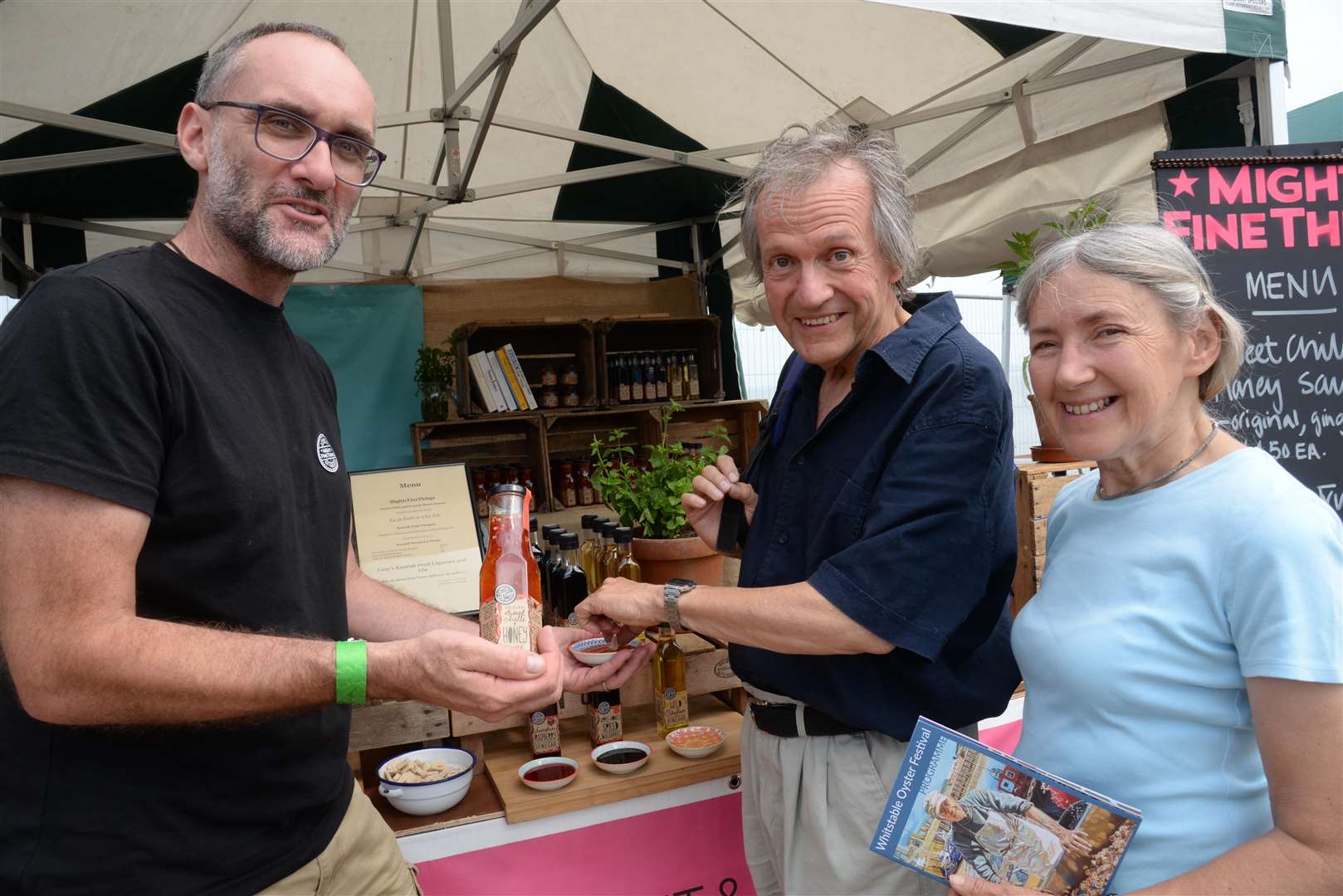 Rob Newton of Mighty Fine Things offers a tastying to John and Christine Chappell at the Oyster Festival food fair on Tankerton Slopes on Sunday. Picture: Chris Davey... (3195135)