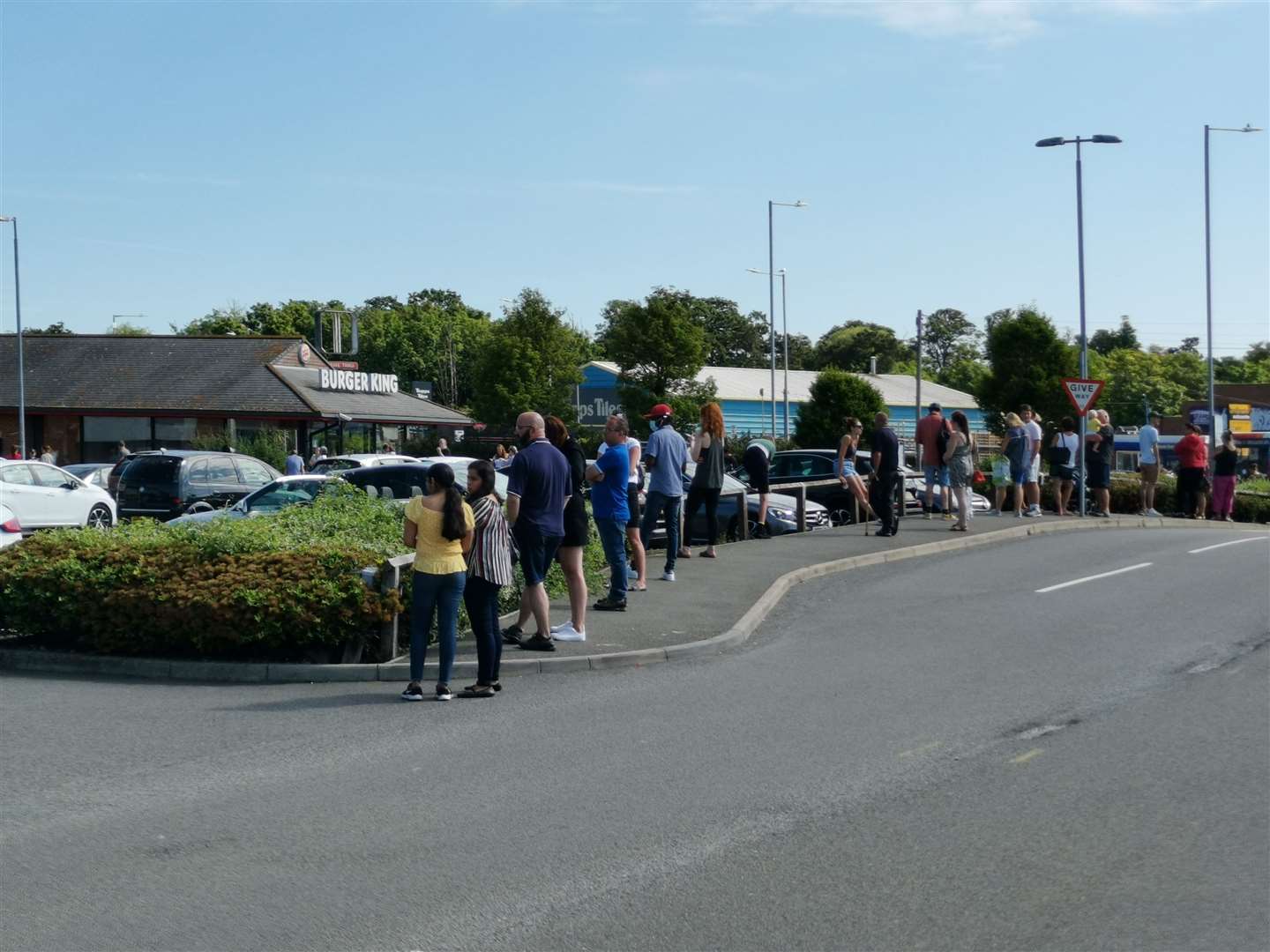 Shoppers waiting outside Sports Direct at Westwood Cross