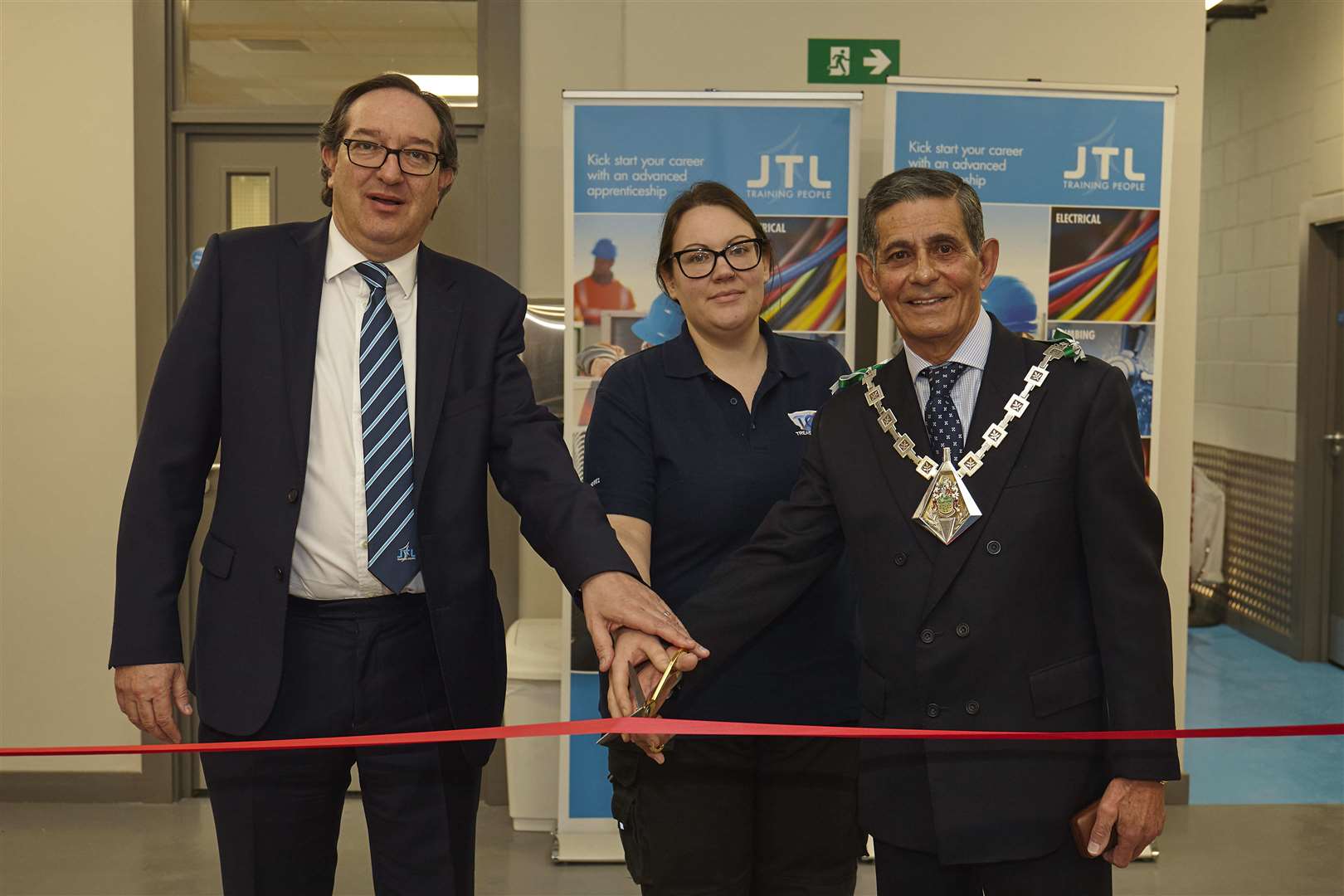 Cutting the ribbon at the JTL training centre, from left, JTL chief executive Jon Graham, third-year apprentice Hannah Barker who works for Treasury Electrical Services SE and the Mayor of Ashford, Cllr Winston Michael