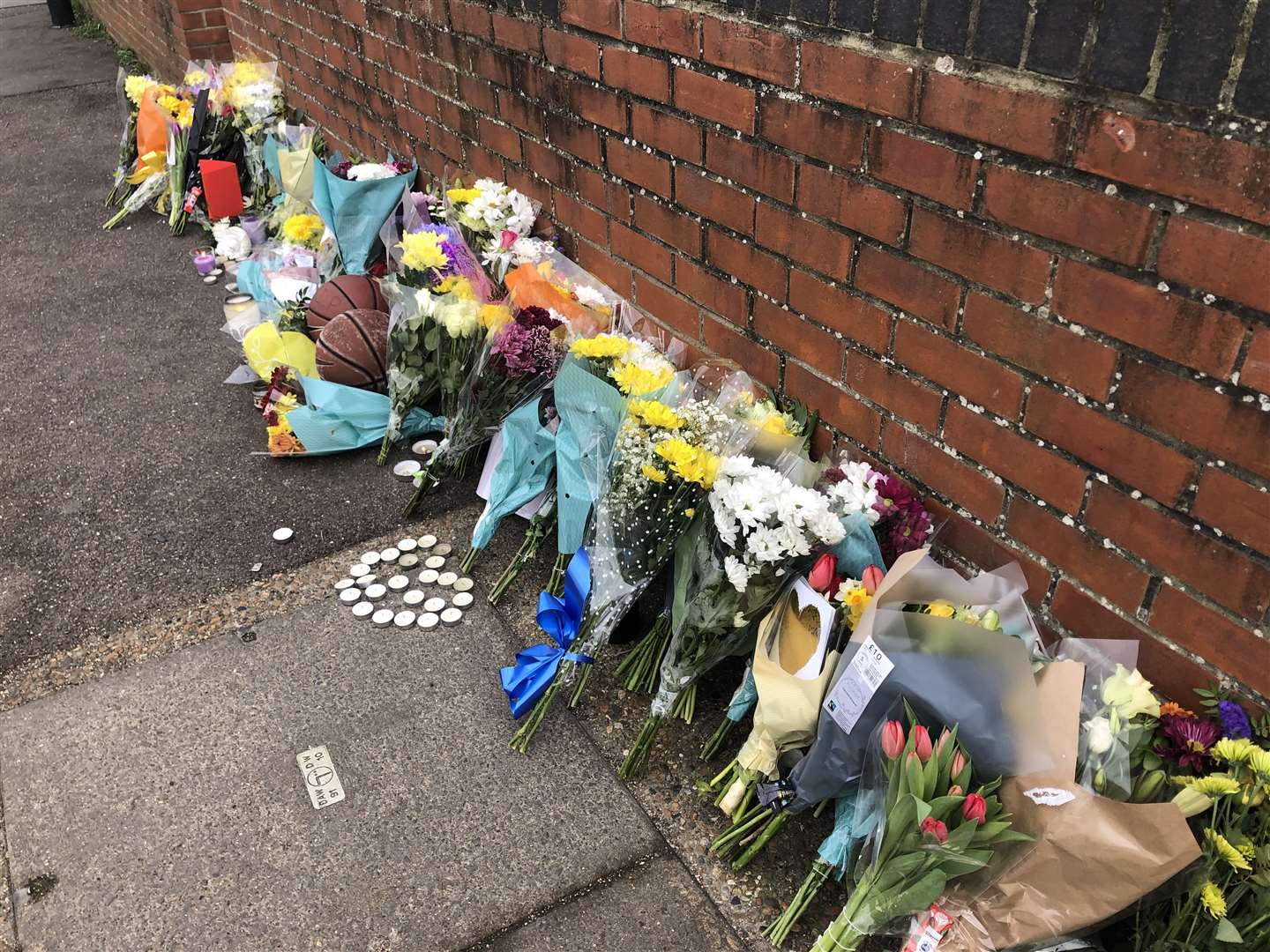 Floral, candle and basketball tributes have been laid in Vale Road