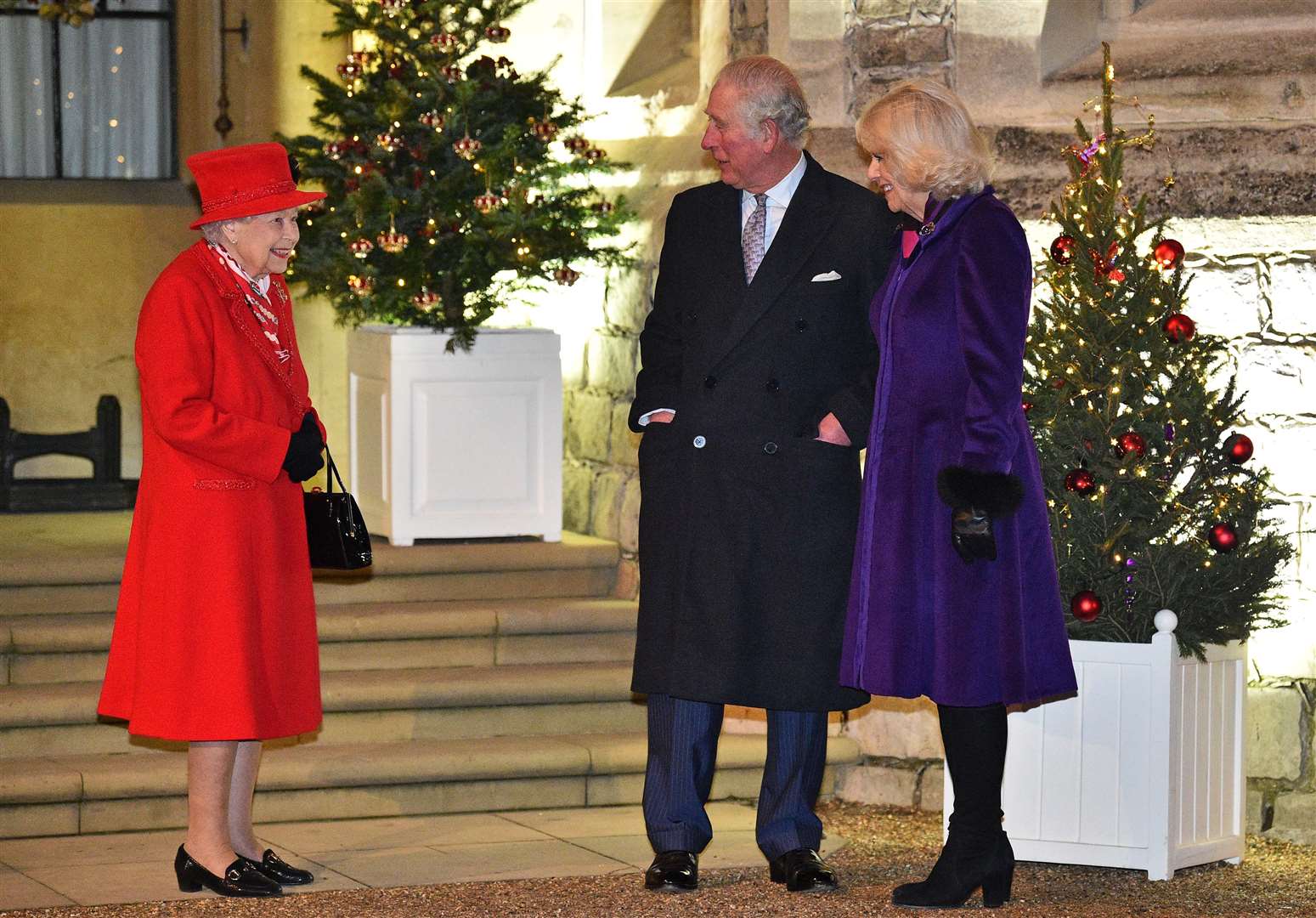 The Queen stands with the Prince of Wales and the Duchess of Cornwall (Glyn Kirk/PA)